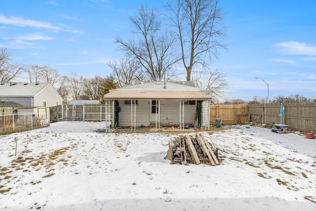 view of snow covered rear of property