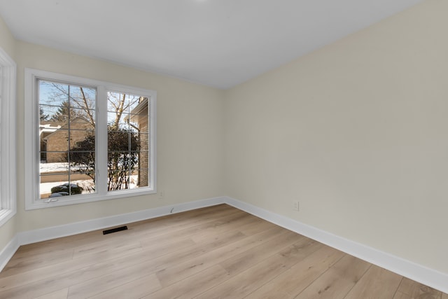 spare room featuring light hardwood / wood-style flooring