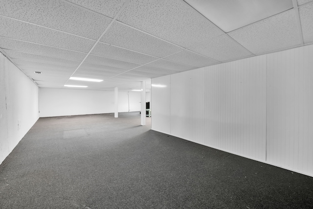 basement with carpet floors and a drop ceiling