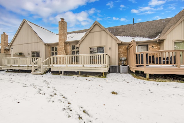 snow covered property featuring a wooden deck and cooling unit