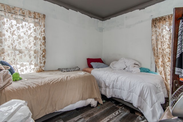 bedroom with hardwood / wood-style flooring and ornamental molding