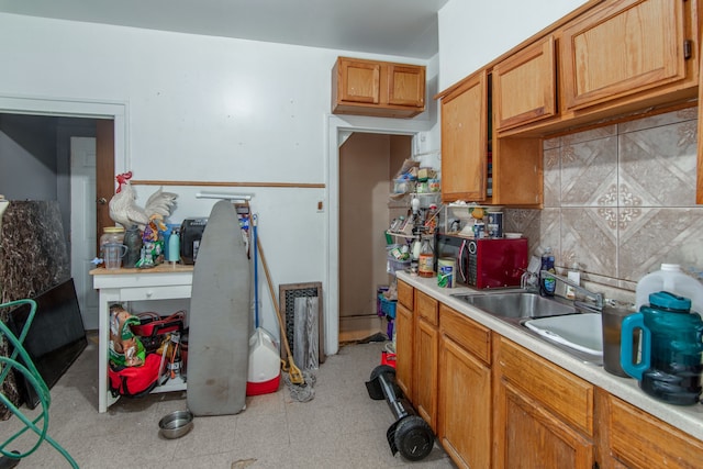 kitchen featuring sink and tasteful backsplash