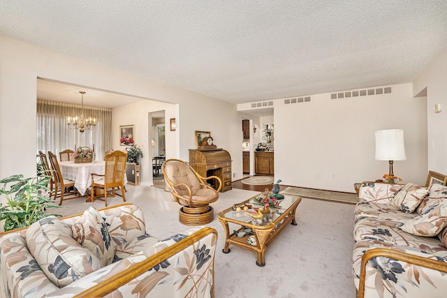 living room with a textured ceiling and a notable chandelier