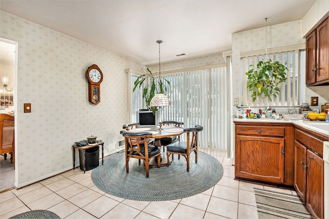 dining room featuring sink and light tile patterned floors