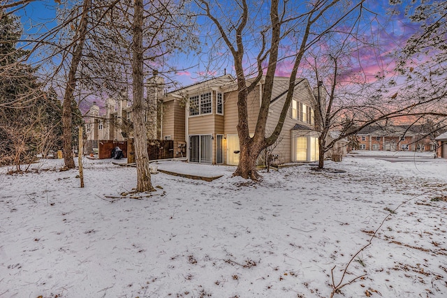 view of snow covered rear of property