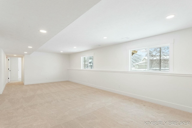 carpeted spare room featuring plenty of natural light