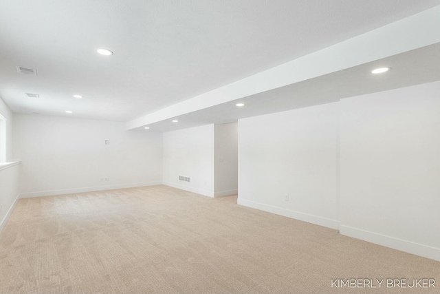 basement featuring light colored carpet