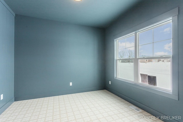 unfurnished room featuring plenty of natural light