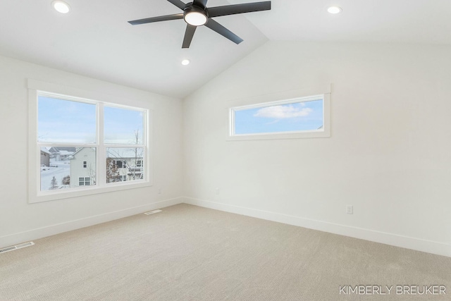 carpeted spare room featuring ceiling fan and lofted ceiling