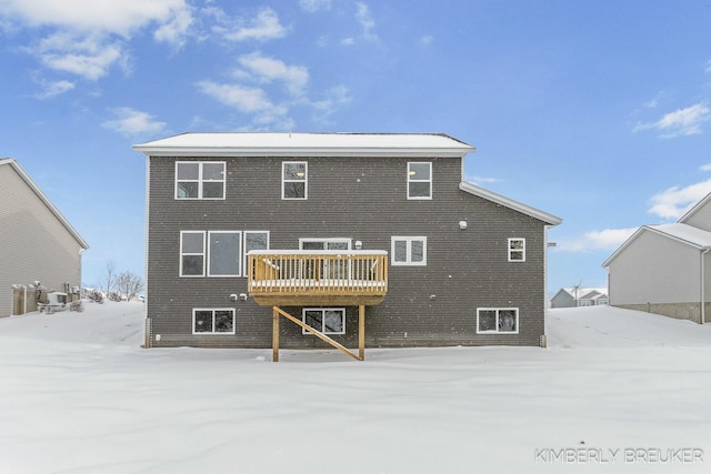 snow covered property with a deck