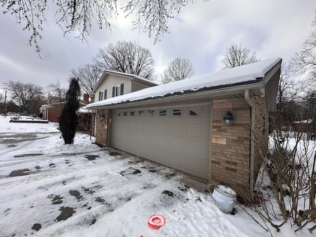 view of snowy exterior with a garage