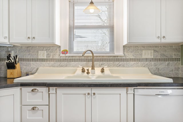 kitchen with dishwasher, dark countertops, backsplash, and white cabinets