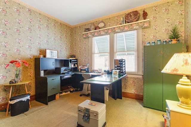 carpeted home office featuring baseboards, crown molding, and wallpapered walls