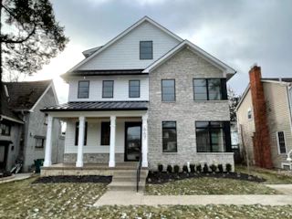 view of front of home with a front yard and a porch