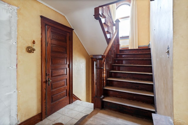 staircase with lofted ceiling