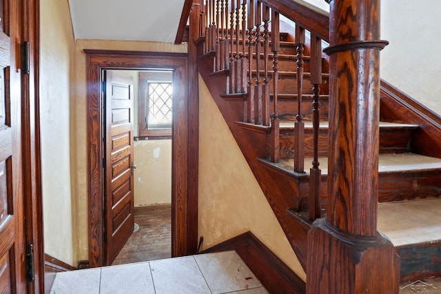 staircase featuring tile patterned floors