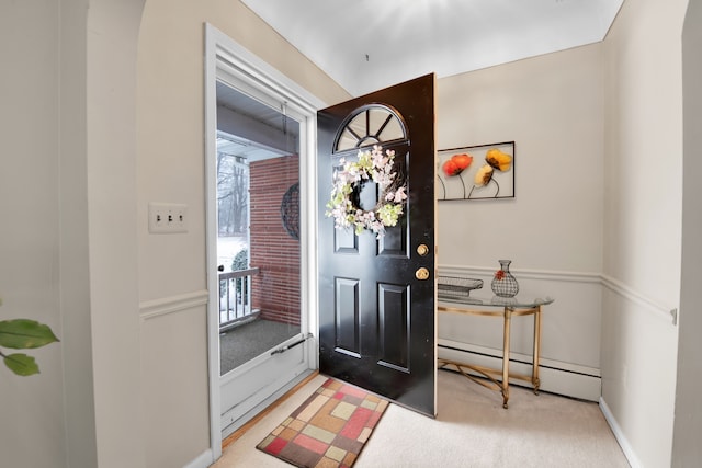 carpeted foyer featuring a baseboard heating unit