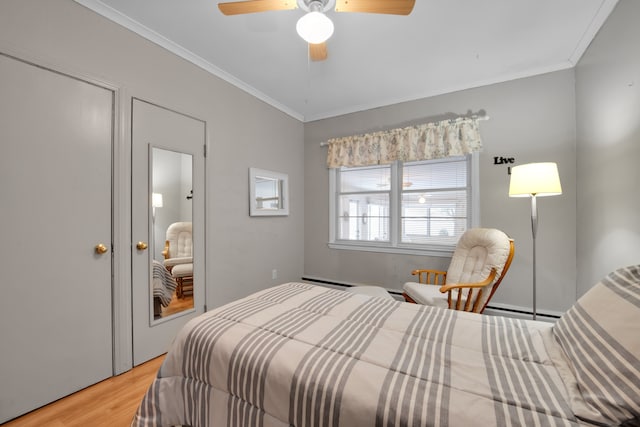 bedroom featuring ceiling fan, ornamental molding, and wood-type flooring