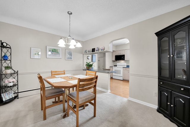 dining space featuring baseboard heating, an inviting chandelier, light carpet, and a textured ceiling