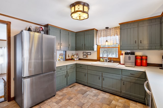 kitchen featuring sink and stainless steel refrigerator