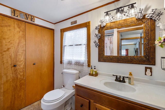 bathroom featuring ornamental molding, vanity, and toilet