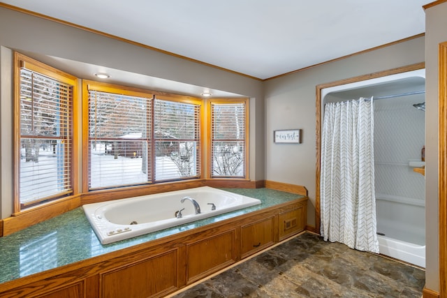 bathroom with ornamental molding and shower with separate bathtub