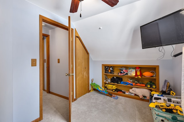 rec room with lofted ceiling, light colored carpet, and ceiling fan