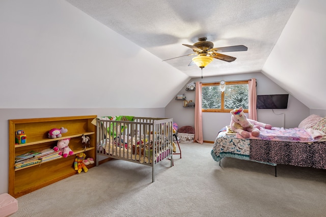 bedroom with vaulted ceiling, light colored carpet, a textured ceiling, and ceiling fan