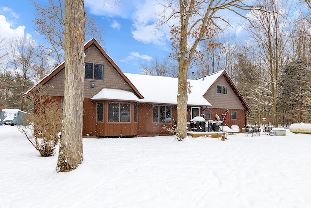 view of snow covered back of property