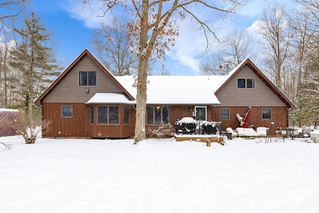 view of snow covered rear of property