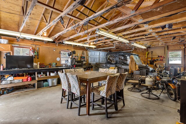 dining space featuring a workshop area and concrete floors