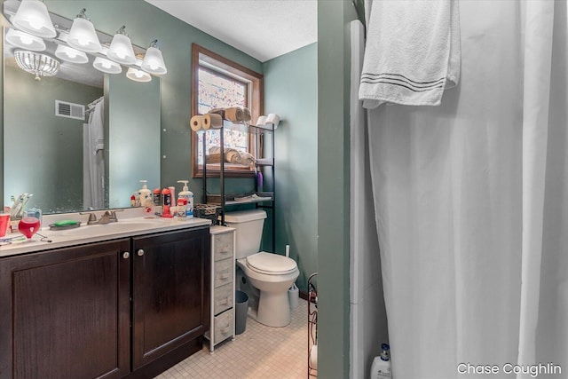 bathroom featuring vanity, toilet, and a textured ceiling