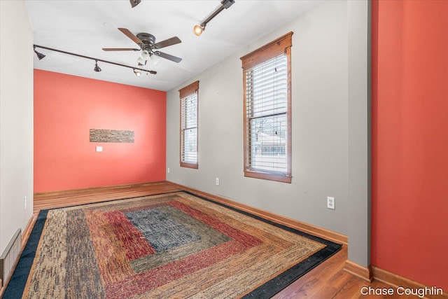 spare room with hardwood / wood-style flooring and ceiling fan