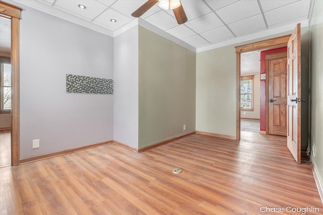 unfurnished room featuring ceiling fan, a paneled ceiling, crown molding, and light hardwood / wood-style flooring