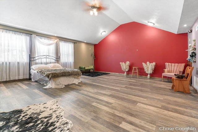 bedroom featuring hardwood / wood-style flooring and lofted ceiling