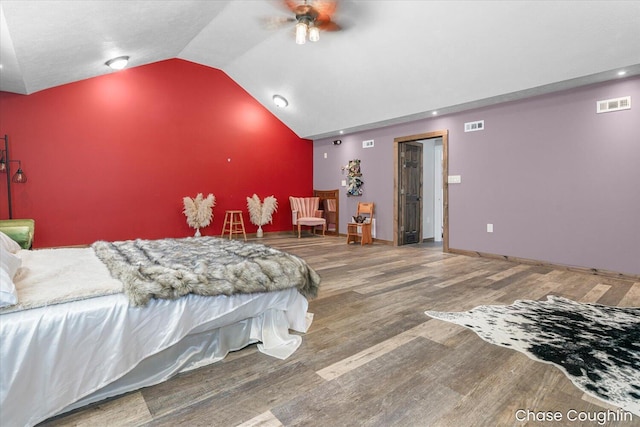 bedroom featuring ceiling fan, hardwood / wood-style floors, and lofted ceiling