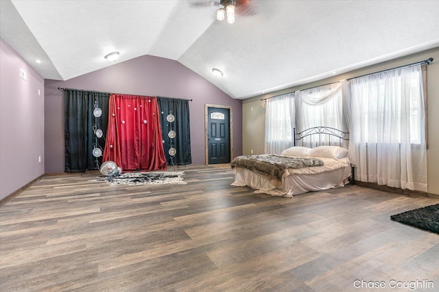 bedroom featuring hardwood / wood-style floors and lofted ceiling