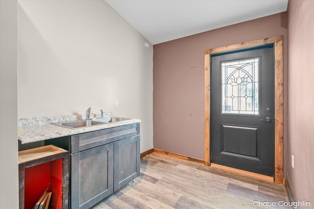 entryway featuring sink and light hardwood / wood-style flooring