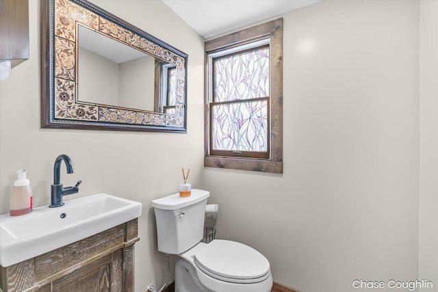 bathroom with toilet and vanity