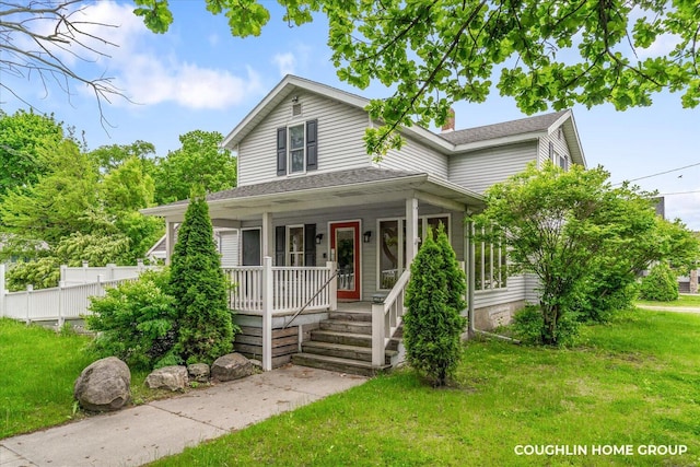 502 W State St, Hastings, MI 49058 - view of front of property featuring a porch, a front yard, and a shingled roof