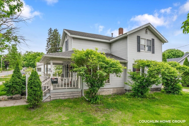 502 W State St, Hastings, MI 49058 - view of front of home with a front yard, a shingled roof, and a chimney