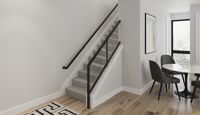 stairs featuring hardwood / wood-style flooring