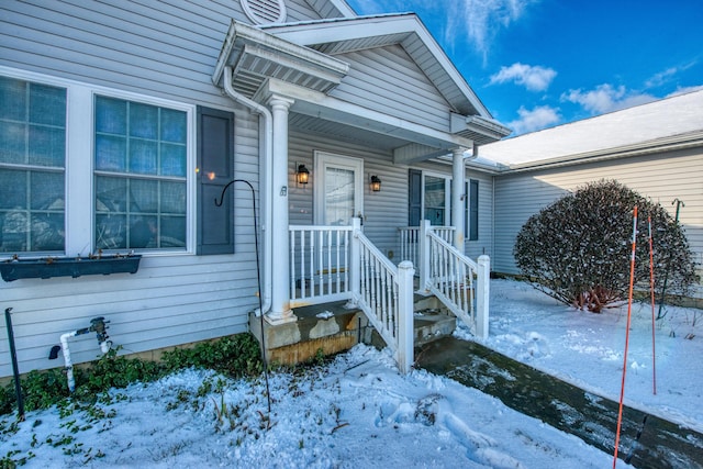 view of snow covered property entrance