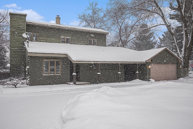 view of snow covered back of property