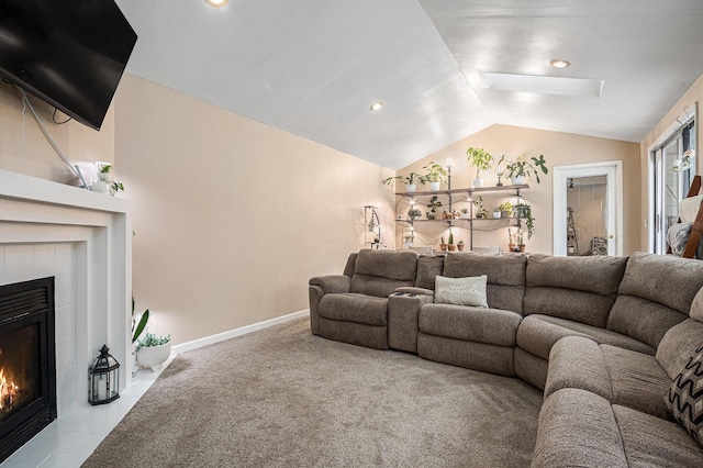 living room featuring a tile fireplace and lofted ceiling