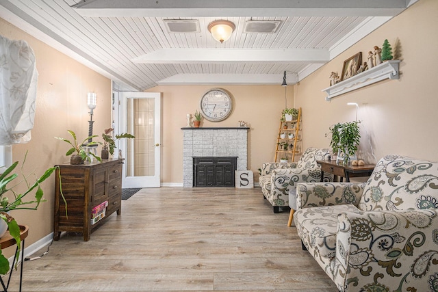 living room featuring wooden ceiling, light hardwood / wood-style floors, and lofted ceiling with beams