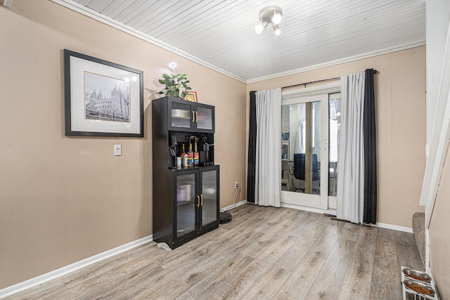 interior space with crown molding and light wood-type flooring