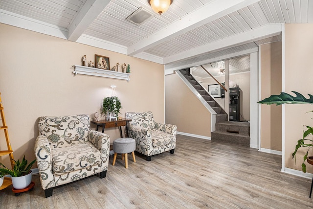 sitting room featuring hardwood / wood-style flooring and beam ceiling