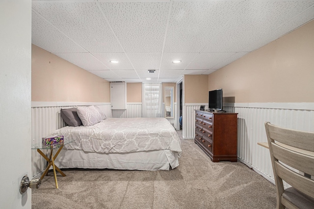 bedroom featuring a paneled ceiling and light colored carpet