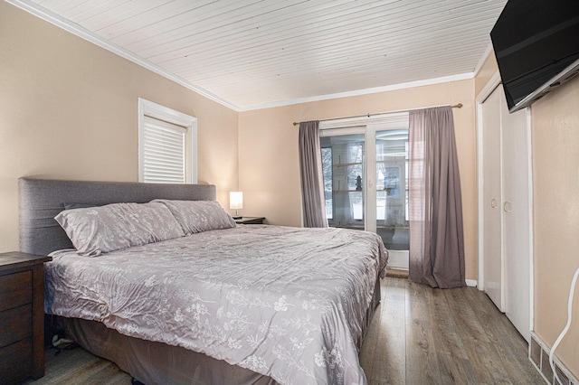 bedroom featuring hardwood / wood-style flooring, ornamental molding, and wooden ceiling